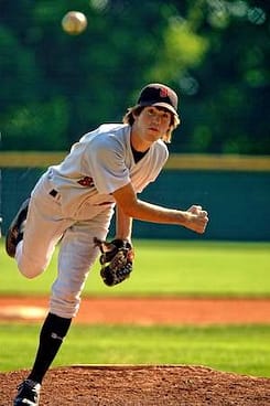 high school pitcher mid pitch who is practicing to lower his ERA