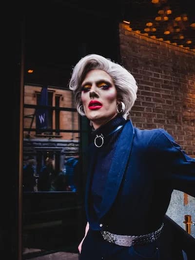 drag queen walking down the street with blue suit