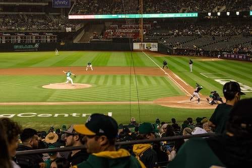 View from the seats of a Baseball pitcher throwing to a batter 