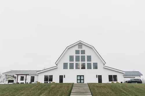 white wedding barn perched on a hill