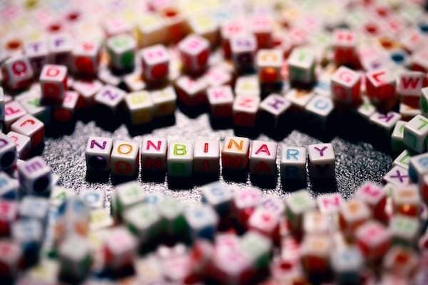 nonbinary spelled out clearly among other blurred letter blocks