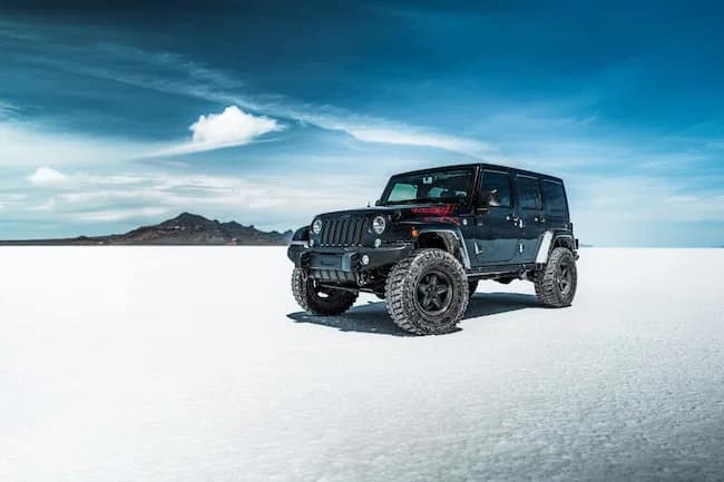 jeep on the salt flats with a blue sky