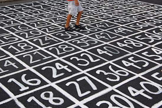 a lot of numbers on the ground with a person in the middle