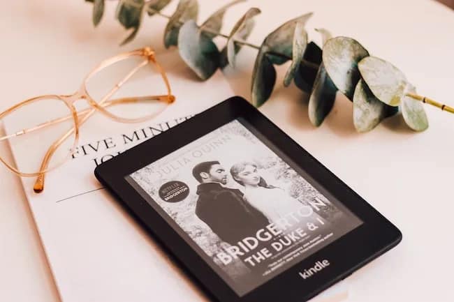 bridgerton book on kindle with leaf and glasses