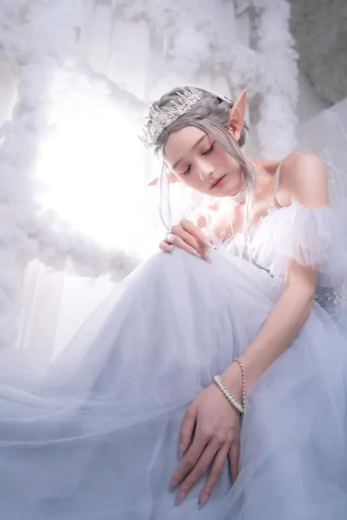 half elf wearing a white dress with sun light by window