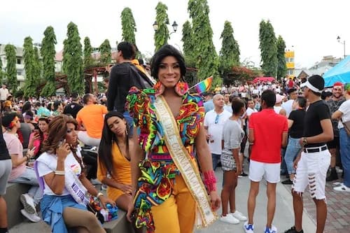 drag king standing in a crowd of other drag kings at a festival