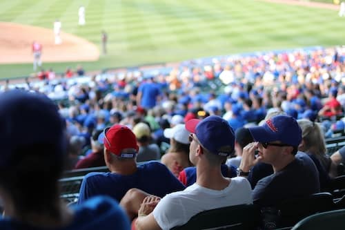 chicago cubs fans sitting in the stadium talking